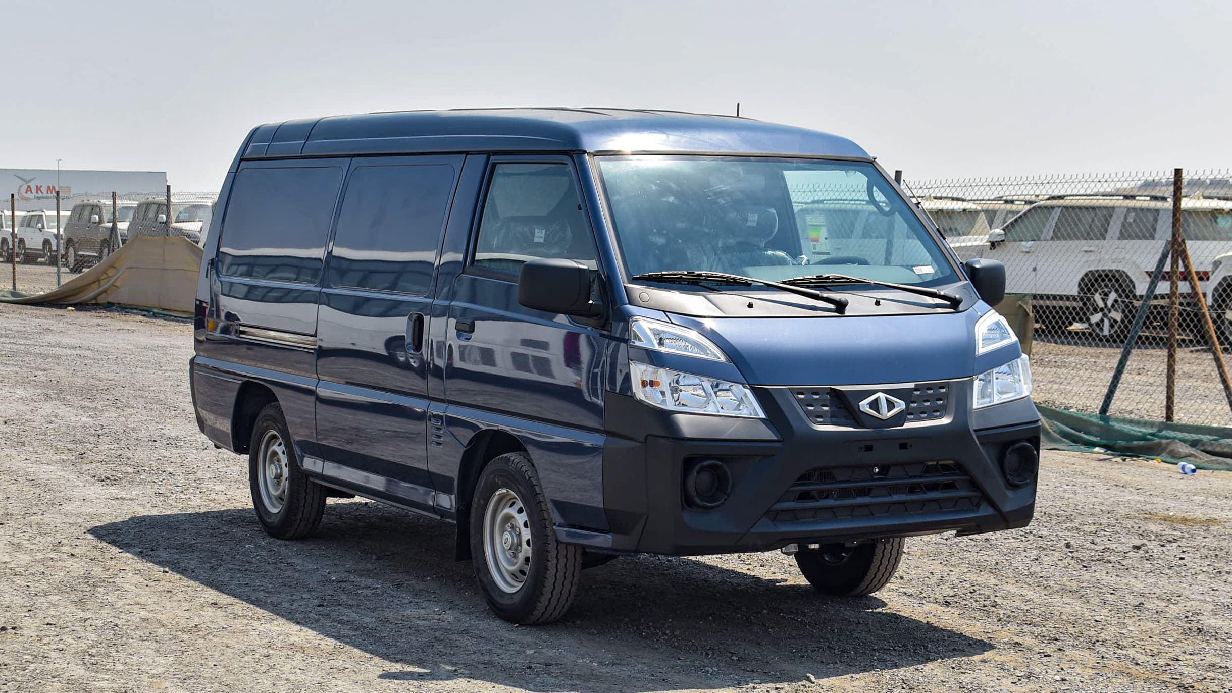 CMC dark blue commercial panel van parked at dealership lot in Sudan